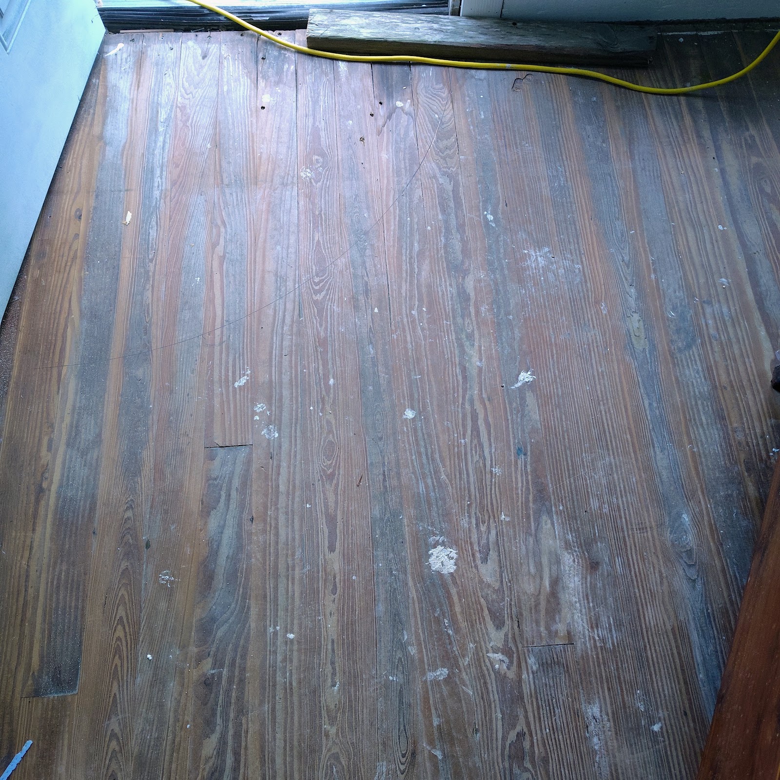 Worn hardwood floor before